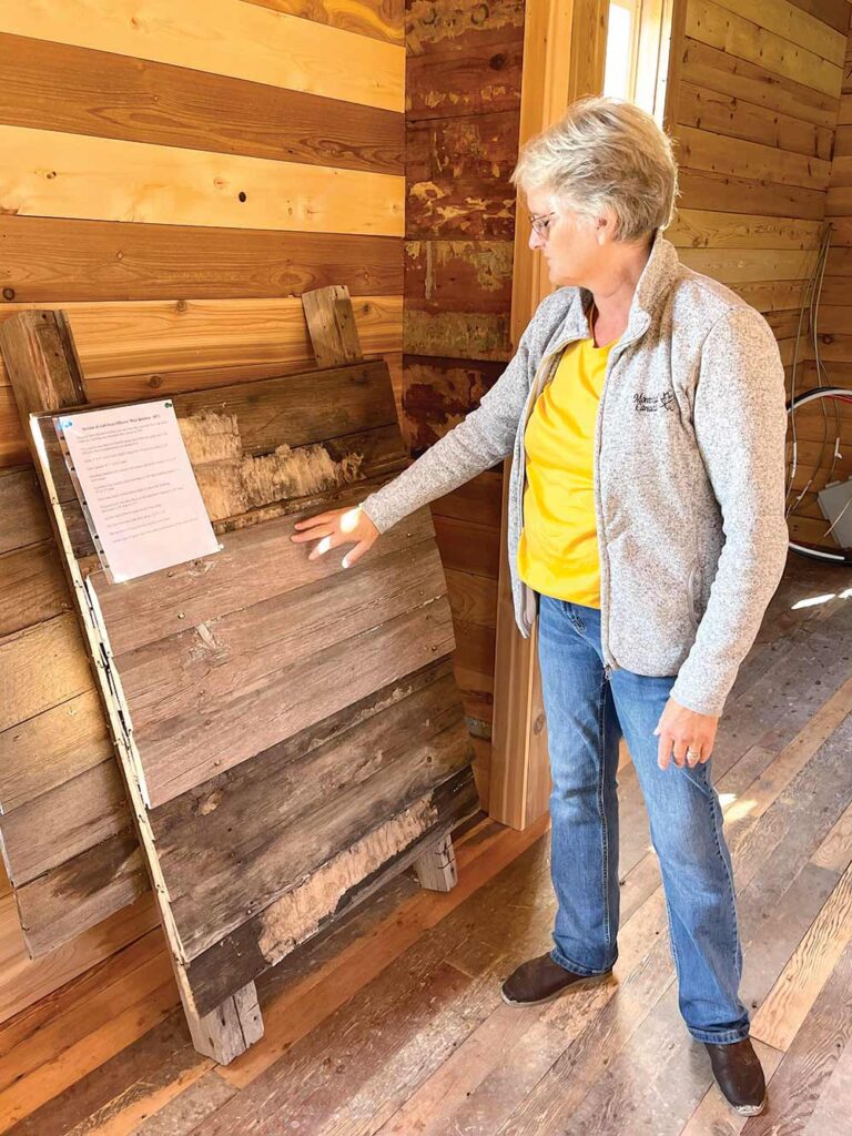 Empson with some of the original lumber from the officer’s mess kitchen, which was used by the British-Canadian contingent of the International Boundary Commission from 1872-74