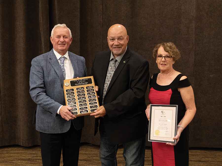 Mike and Julie Clarke receiving their award from Laurie Hunt, MGRA vice-president and judge