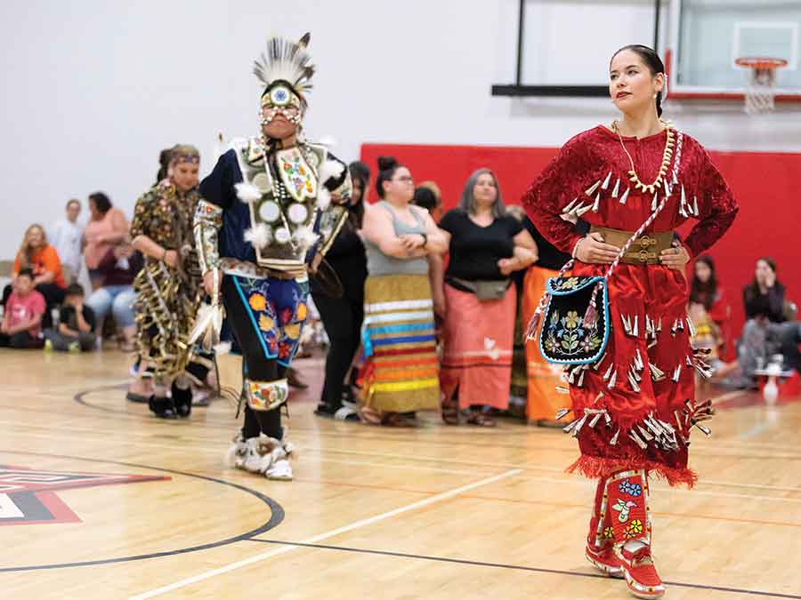 Traditional pow wow dancer with Carman Collegiate graduate Cherish Williams in her jingle dress