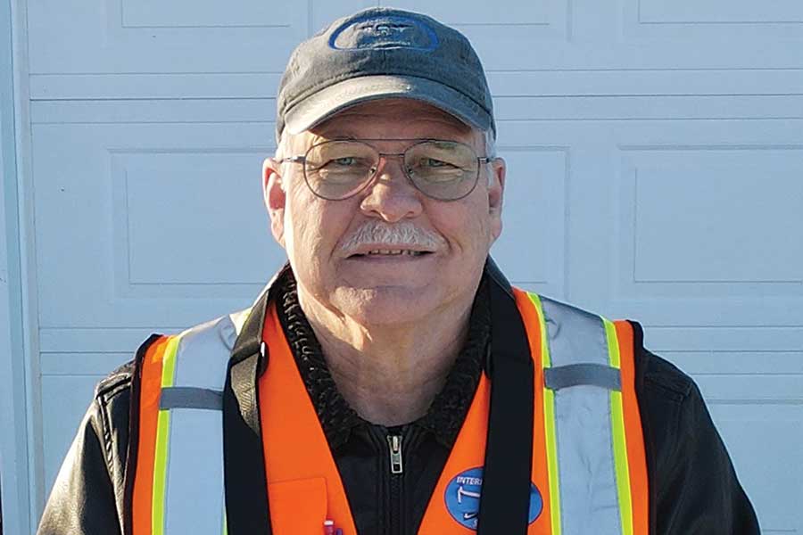 Steve Bannister of Interlake Drone Services operates a drone with his handheld controller during an aerial photography job