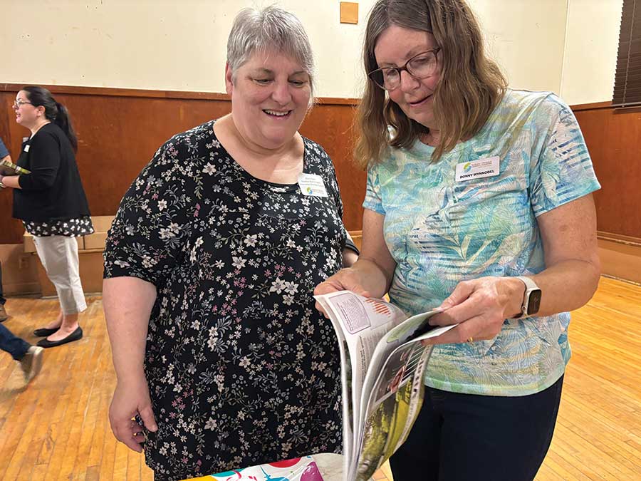 Marie Cayer and Bonny Wynnobel checking out the Vital Signs report