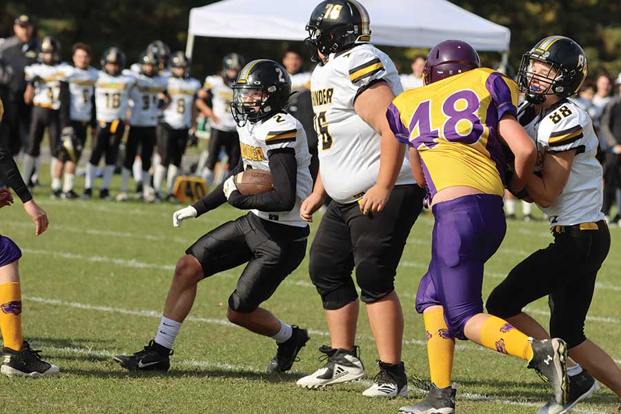 The Thunder’s Dylan Maclean carries the ball with blockers Jayden Buors (76) and Kaiden Reimer (88) providing protection