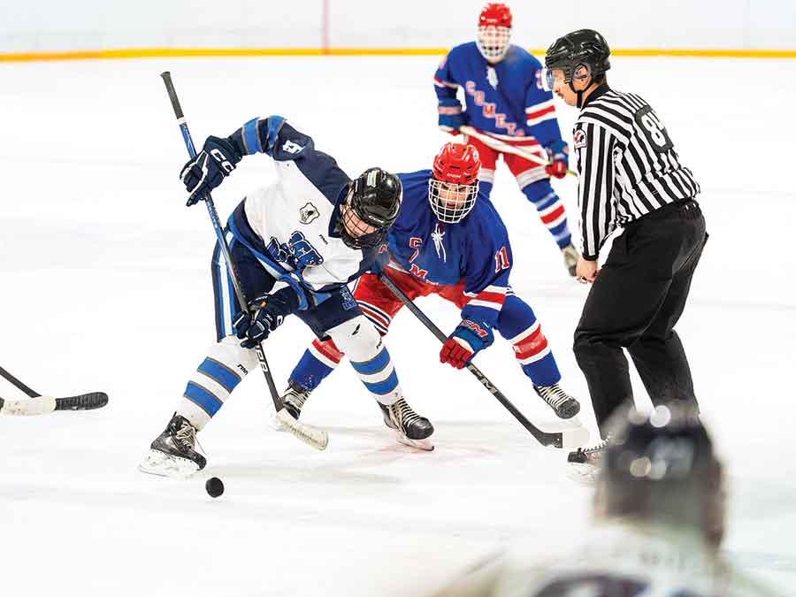 Falcons’s Noah Smolinski takes control off the draw in Friday’s matchup against the Beausejour Comets