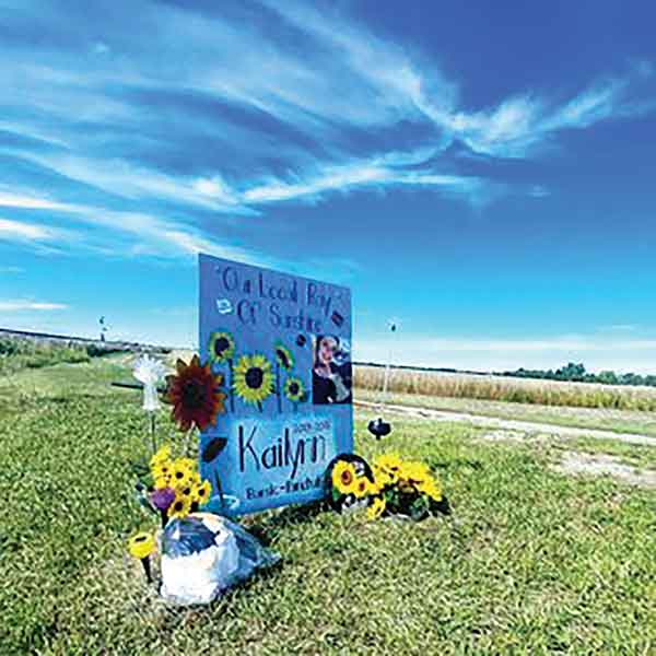 A roadside memorial marks the site of the 2018 crash where Kailynn Bursic-Panchuk was fatally injured after glancing at her phone while driving