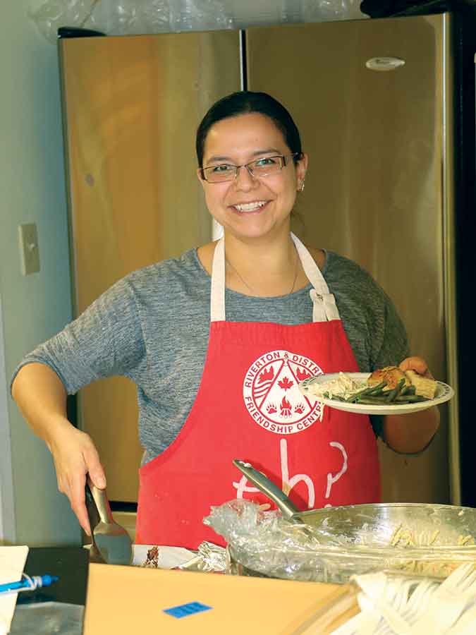 Riverton & District Friendship Centre staff member Martine Sawanas is shown in 2017 preparing a nutritious meal for local children