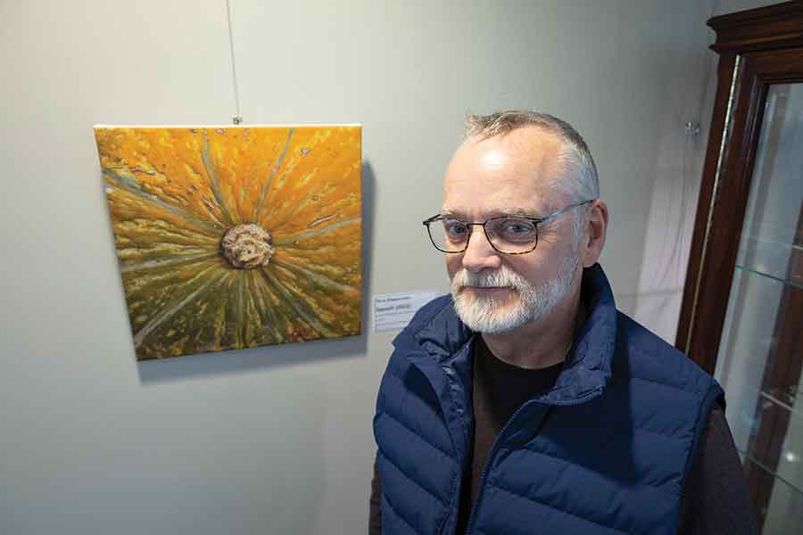 Terry Klippenstein (above) and daughter Olivia (on the title) in front of a few of their pieces now on display at The Gardens on Tenth in Altona