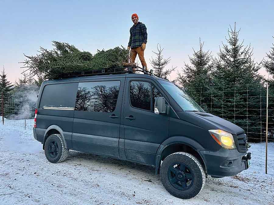 Christmas spirit on the move — a Mount Nebo Trees customer loads up his holiday greenery for the journey home
