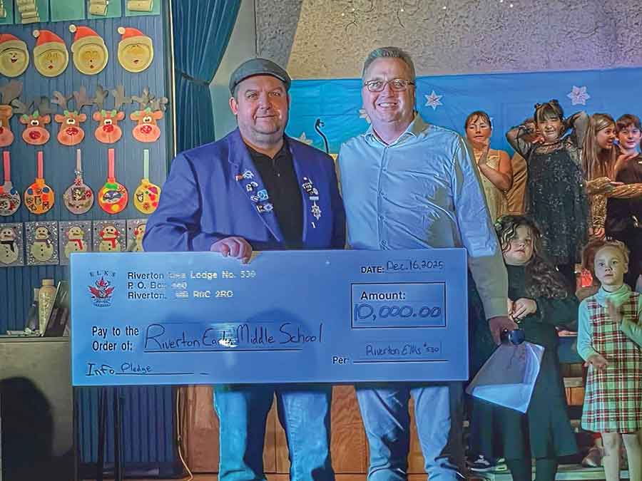 Riverton Elks member Mitch Johnson, left, presents a $10,000 donation to Riverton Early Middle Years School principal Randy Seminuk in support of the school’s playground project