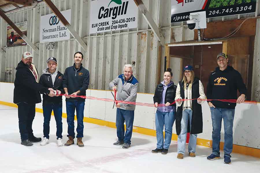 Elm Creek Arena board members Tyra McIntyre, Kaylee Goerzen, Jarryd Fortin, Brad Tkachyk, Daniel Lepp and Kelvin Thielmann hold the ribbon, at the ribbon cutting ceremony, as Lorne Zacharais declared the Elm Creek Skating Rink Artificial Ice Project completed