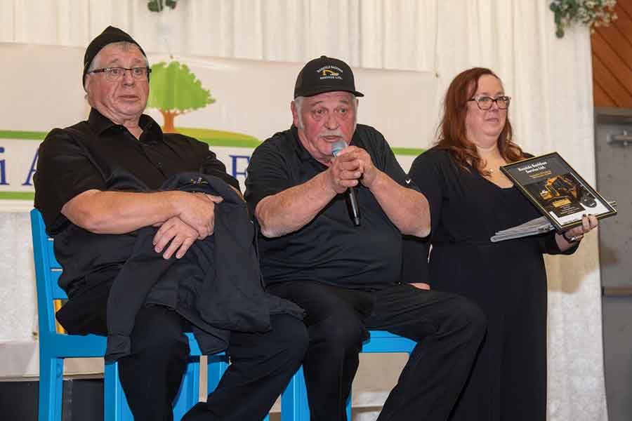 Morris Olafson, middle, auctions a number of prizes