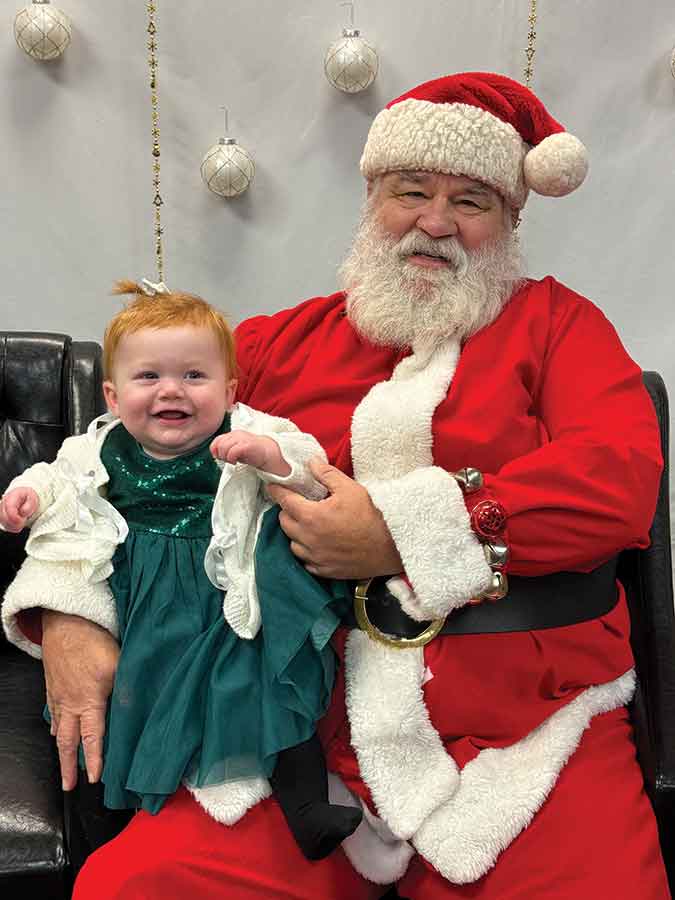 Eight-month-old Sidney visits with St. Nick