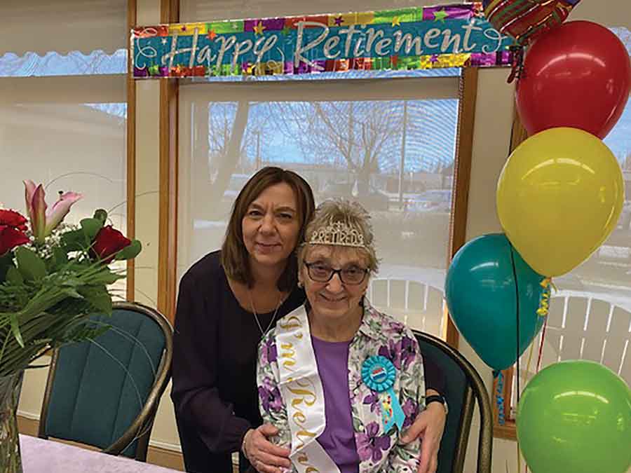 Lillian Bilynsky, sitting, celebrates her retirement with long-time colleague and “adopted daughter” Kelly Broek at the Whitemouth personal care home in November. Bilynsky, who began her career in 1963, retires after an extraordinary 62 years in local health care