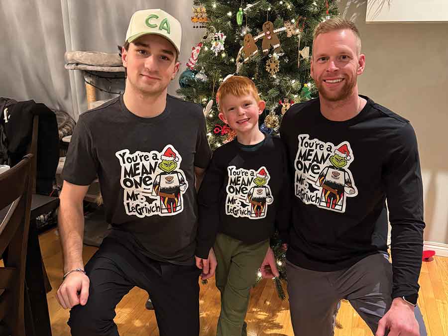 Raiden LeGall with Morison and his son Mavryk and the Grinch version of the logo that started it all