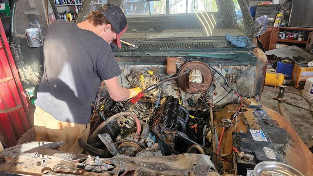 Owen was working on the motor, installing a new manifold, carburetor, valve covers and distributor