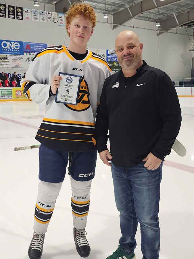 Stonewall Jets general manager Liam Wheddon (left) presents Gavin Holod with the Manitoba Major Junior Hockey League Player of the Month plaque for November 2025