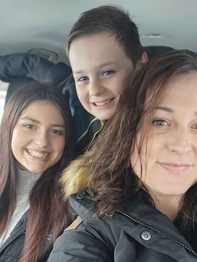 Kwin, middle, recently diagnosed with Burkitt lymphoma, is surrounded by love and support from his mom Kim and sister as he begins treatment