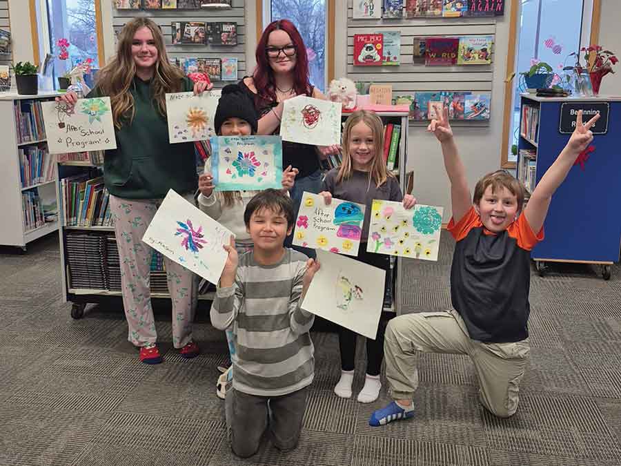 Lundar teens Dylan Tkach and Alyssa Christensen host an after-school program twice a week at the Lundar Pauline Johnson Library for students in grades 1 through 4. Pictured at the back are Christensen and Tkach, with Emersyn, Gracie, Mason and John