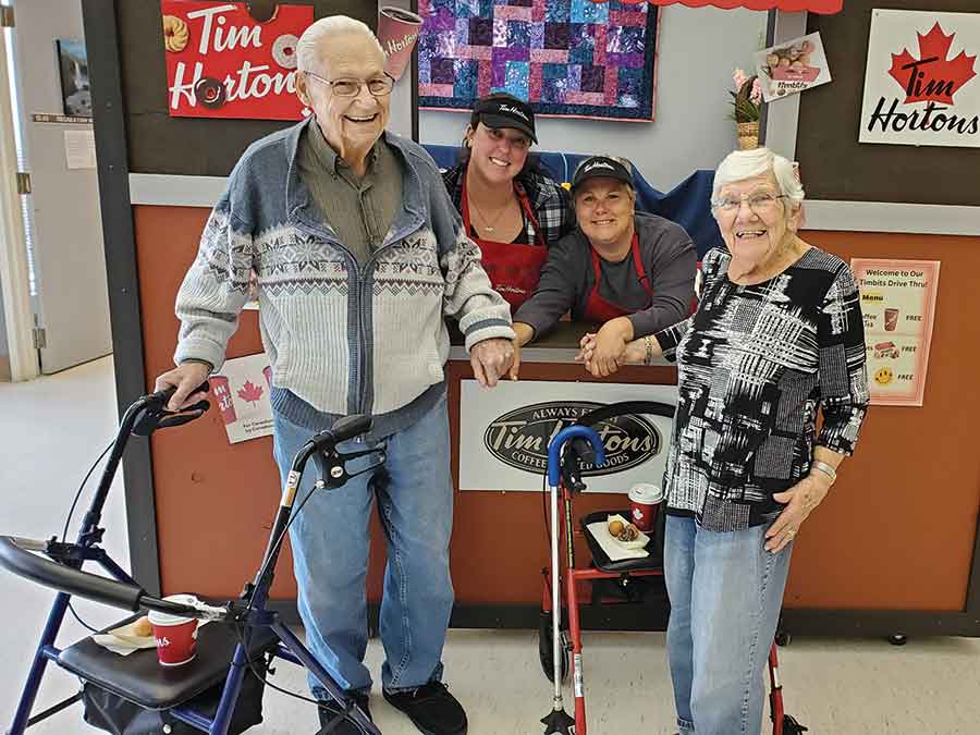 From left George (resident), Ashley Ayres, Therapeutic Recreation Facilitator, Trista Allbutt, Therapeutic Recreation Facilitator, and Martha (resident). George and Martha are one of four married couples currently residing at Gimli Betel Home together