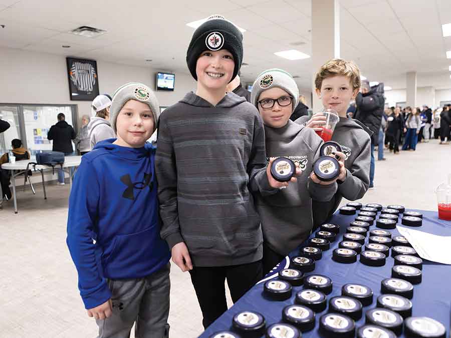 Local hockey players Chase From, John Frost, Ryker Isfjord, Levi Murphy, Gordie Scrivens and Trey Warburton helped collect pucks during the chuck-a-puck contest