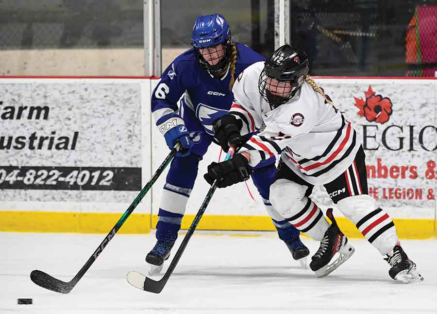 Lightning’s Emma Boonstra and Hawks forward Bree Pearce battle for the puck