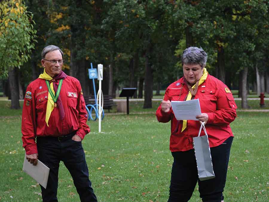 Carman Scout volunteer leader Edwin Pritchard accepts his 40-year anniversary pin and plaque from fellow volunteer Lynne Melvin