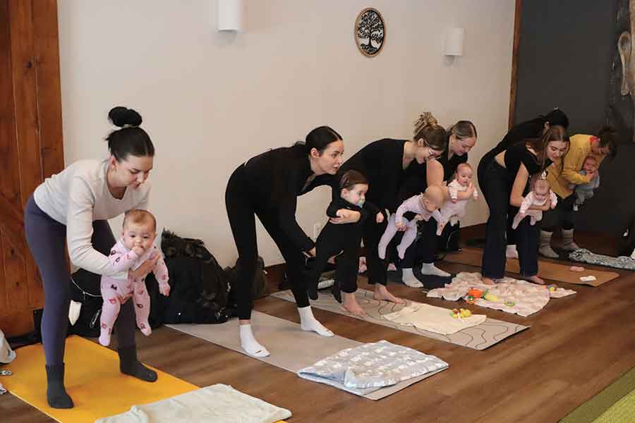 Mothers and their babies move through gentle yoga and infant-led activities