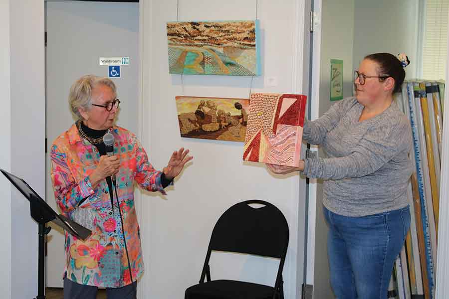 Artist Naomi Gerrard speaks to members of the Wednesday morning group at the Golden Prairie Arts Council, sharing insights into her Seeds of the Prairies exhibition and the inspiration behind her grain-based mixed media artworks