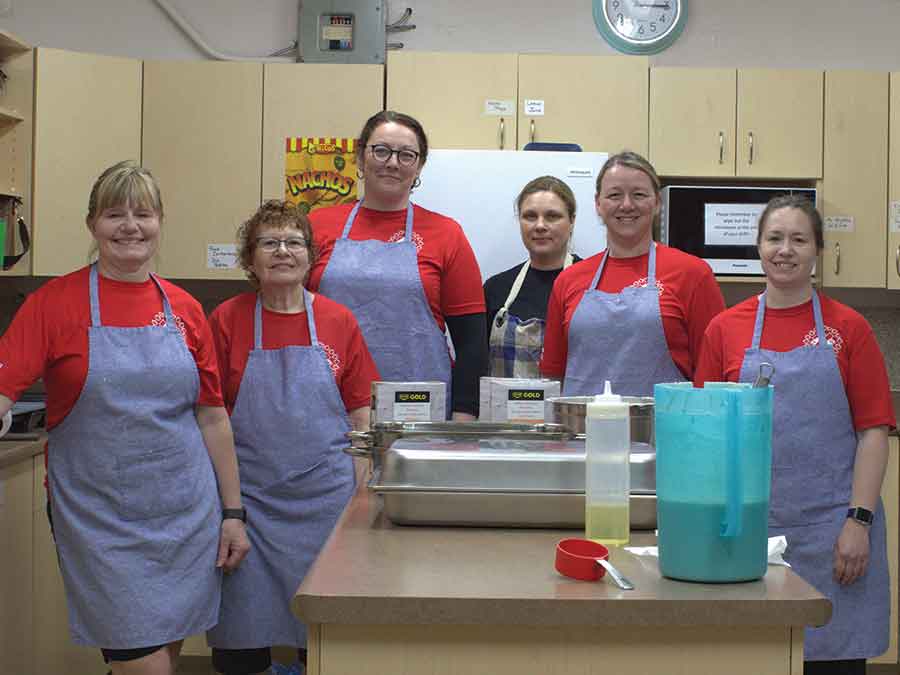 Participants line up at the start of the 6th annual Boyne Book It Fun Run in Carman on May 24, while volunteers in the kitchen prepare a hearty pancake breakfast to fuel the day