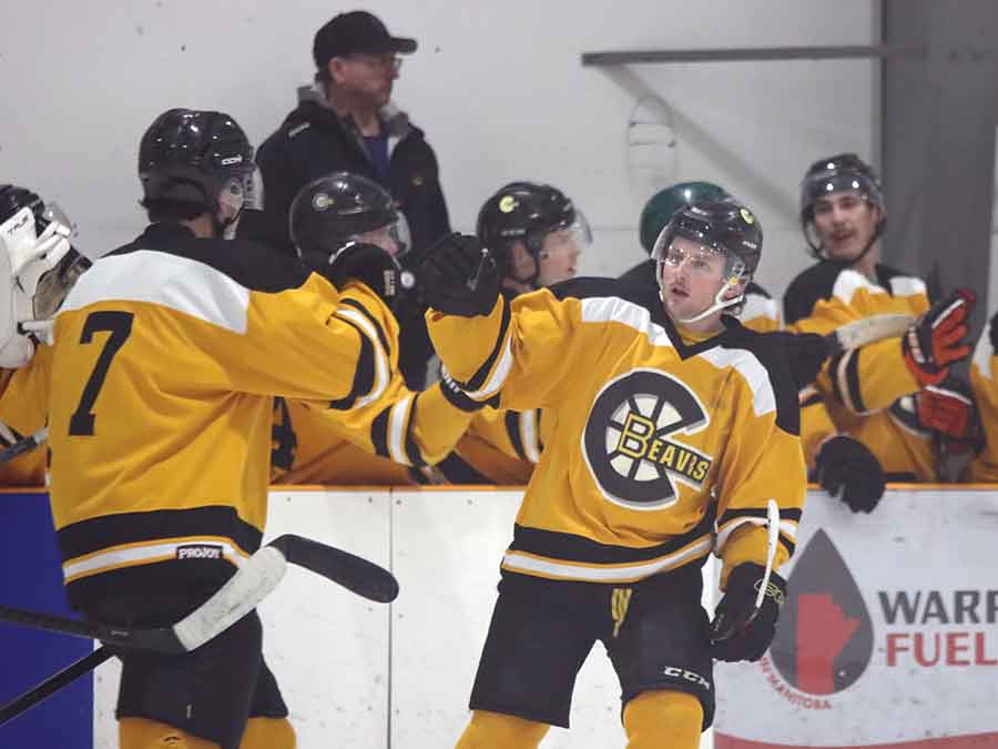 Beavers players exchange high fives after a goal in a 6–3 loss to the Warren Mercs
