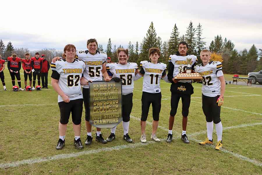 Interlake Thunder captains, left to right, Jake Rogoski, Cooper Ponton, Teagan Peterson, Jamie Dandeneau, Jessie Batenchuk and Kole Beresford, celebrate their 37–36 championship victory over the St. Vital Mustangs as they receive the banner and trophy following Sunday’s Rural Manitoba Football League final at Stonewall Collegiate Field. The win marked the Thunder’s third RMFL varsity title and capped an undefeated 9–0 season