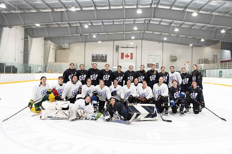 The Warren Wildcats girls and the alumni team