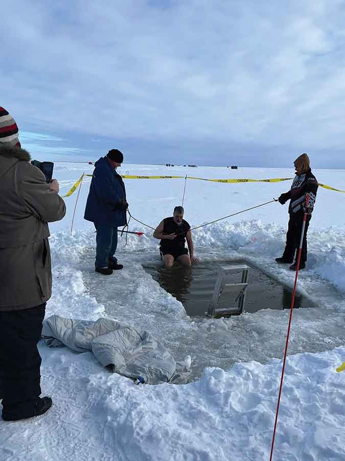 Don Hawryshko takes the plunge into the icy waters of Lake Winnipeg during Gimli’s New Year’s Day Polar Plunge fundraiser in support of Evergreen Basic Needs