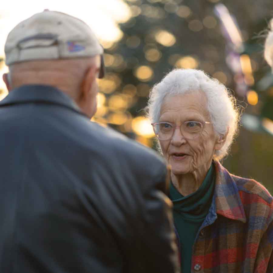 Garden supporter Ina Bramadat visits with artist Jake Goertzen
