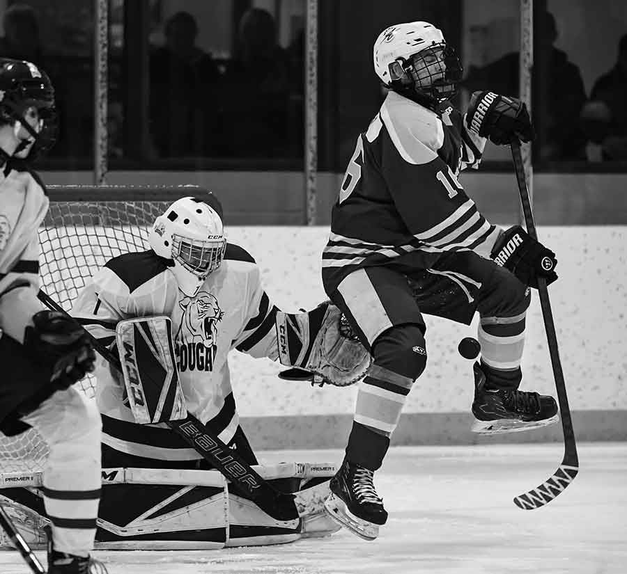 WC MIller Aces’ captain Nolan Franz leaps to avoid a point shot as Carman Cougars goaltender Robby Keith tracks the puck during Zone IV playoff action Feb. 13 in Altona