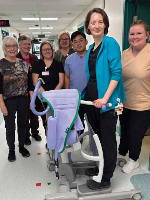 Carman Memorial Hospital staff Madie Gylywoychuk-Winkler, Laureen Kippen, Albert Castro, Rachel Groo and Chantal Banman with Health Auxiliary representatives Kathie Findlay and Darlene Pritchard with the purchasing a sit-to-stand lift
