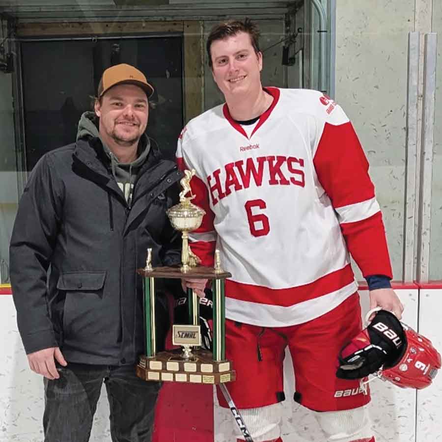 Notre Dame Hawks general manager and head coach Brody Chabbert (left) presents Sean Christensen with the South Eastern Manitoba Hockey League Most Sportsmanlike Player award in Notre Dame on Feb. 14