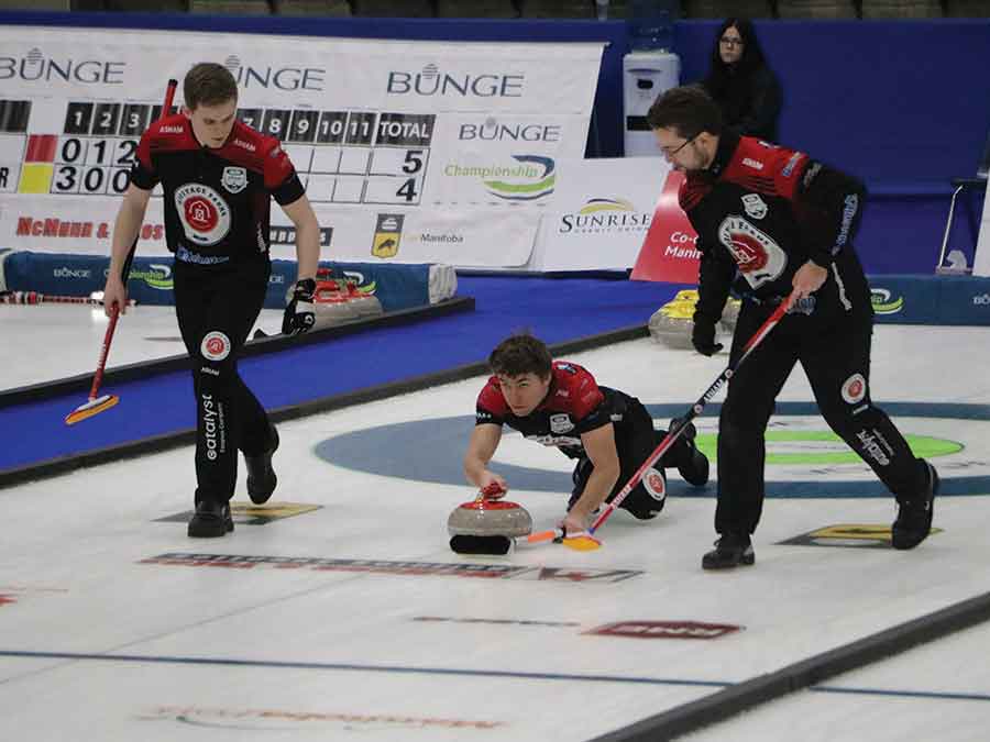 Elias Huminicki delivers a stone during Manitoba men’s curling championship action Sunday at the Selkirk Rec Centre, with sweepers Jacques Gauthier (left) and Cam Olafson. The Jordon McDonald rink reached the final of the Bunge Championship before falling to Braden Calvert’s Heather Curling Club team in an extra end