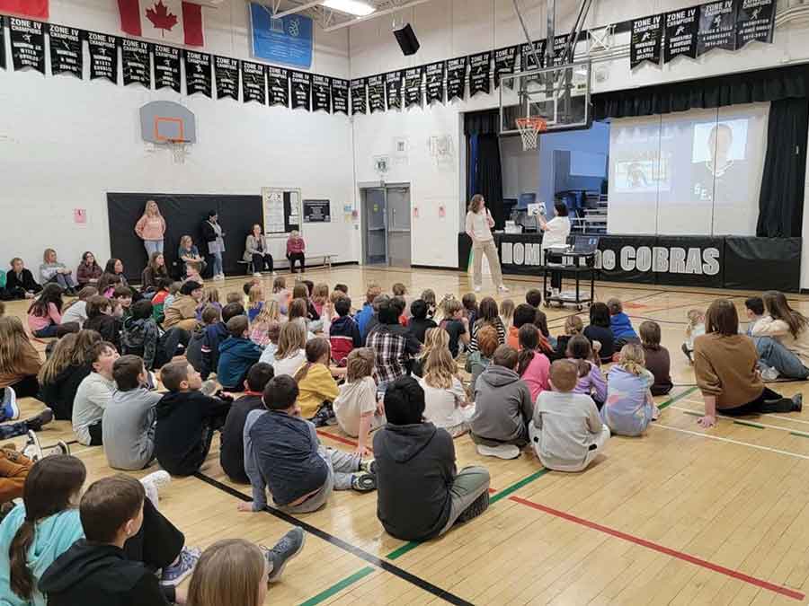 Professional hockey player and former Elm Creek resident, Corinne Schroeder, visits with Elm Creek School students on Feb. 2 for I Love to Read Month