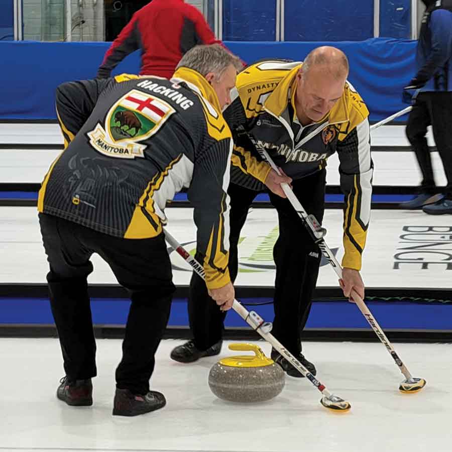 George Hacking, skip of the provincial senior men’s champions, sweeps during a practice game at the Selkirk Curling Club. The game helped break in freshly prepared ice ahead of men’s provincials