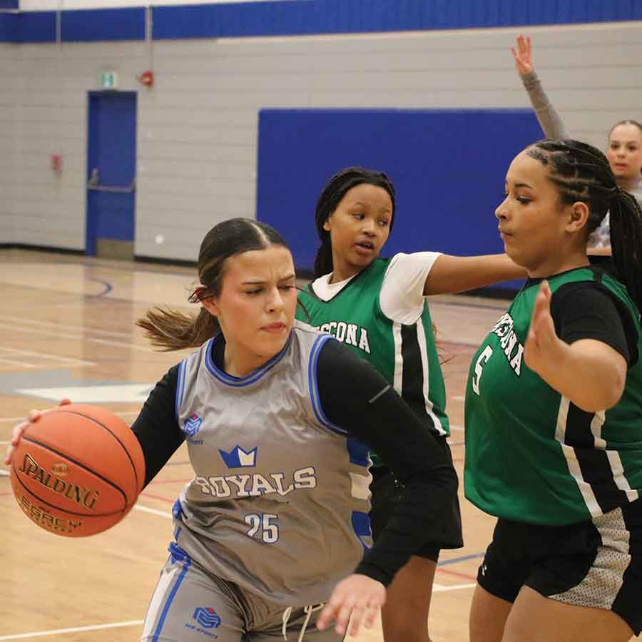 Lord Selkirk’s Emmy Moldwan drives the ball around a pair of Transcona Titans defenders