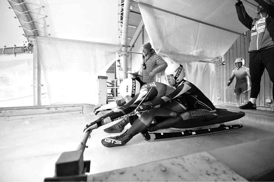 Kailey Allan (back) and Beattie Podulsky (front) preparing for a luge run in competition