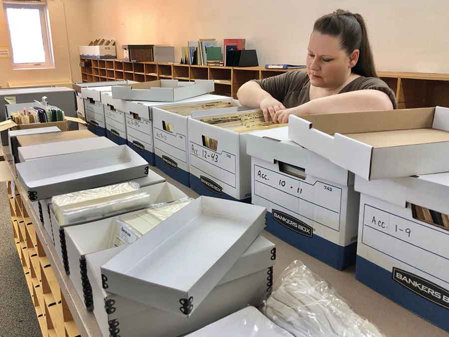 Karen Mah with some of the documents Morden History & Archives is in the process of digitizing