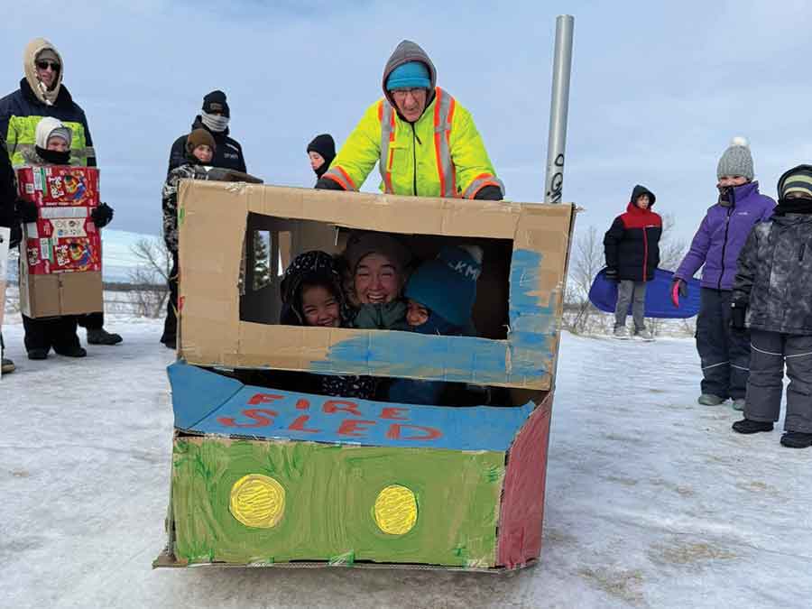 Competitors in the ever-popular Cardboard Toboggan Races at the Altona Winter Carnival start down the hill at Buffalo Creek Nature Park on Saturday