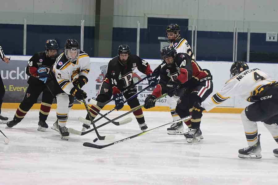 Raiders forwards battle for possession in front of the Stonewall net during Manitoba Major Junior Hockey League action last week, while goaltender Owen Savoie makes a key save in tight coverage as the Jets press the attack