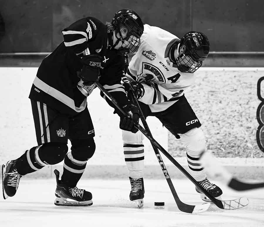 The Wheat Kings’ Benjamin Sveistrup and Hawk Paxton White battle for the puck. Brandon won it 5-0