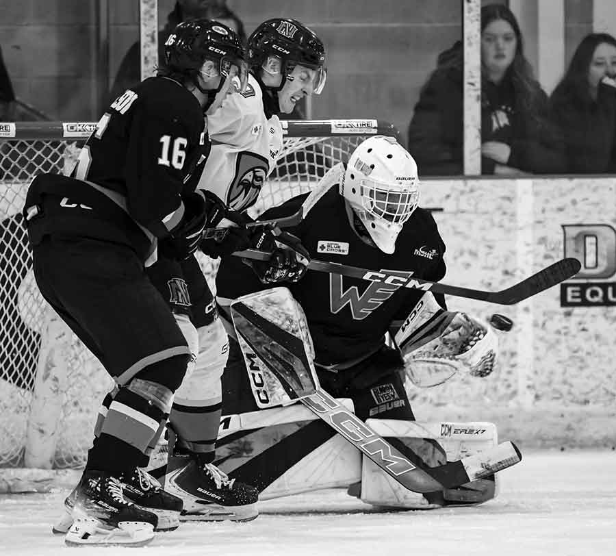With Jacob Michelson and Evan Panzer at the doorstep, Flyers netminder Liam Ernst makes a save during their penalty kill to help keep the Flyers in the lead in their 7-5 win over Niverville Friday night