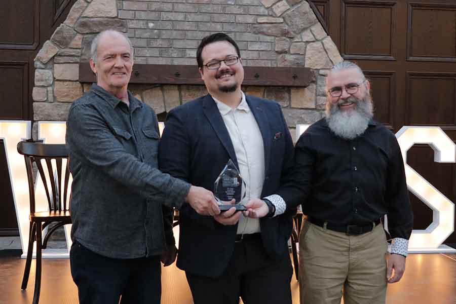 Brad Nelson, Adrien Unrau, and Hank Fehr accepted the Customer Service Award on behalf of EMCO Winkler