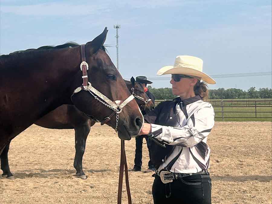 Balanced Motion is a new equine massage service operating in the Interlake. Pictured is owner and founder Amanda Mantik performing gentle tension-releasing techniques with her own horse, Charlie