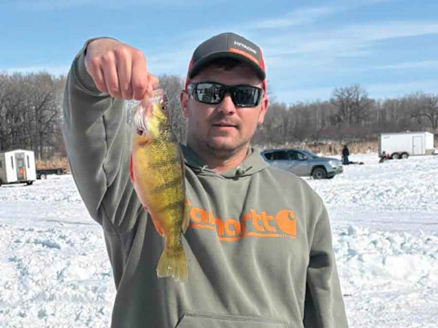 Daniel Janzen holds up the 12-inch perch that earned top honours in the perch category at the Carman & District Game and Fish Association’s annual ice fishing derby on Stephenfield Lake on March 7