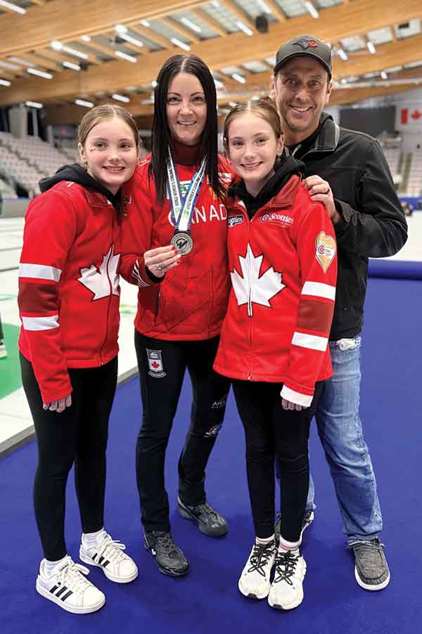 Kerri Einarson celebrates with her daughters Kamryn (left), Khloe and husband Kyle